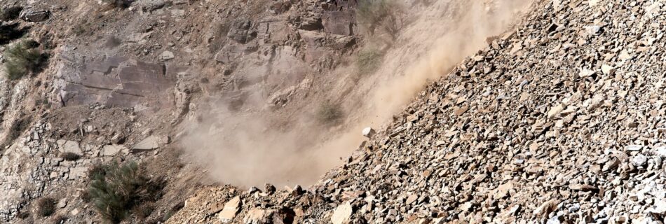 brown rocky slope down to a dirt road